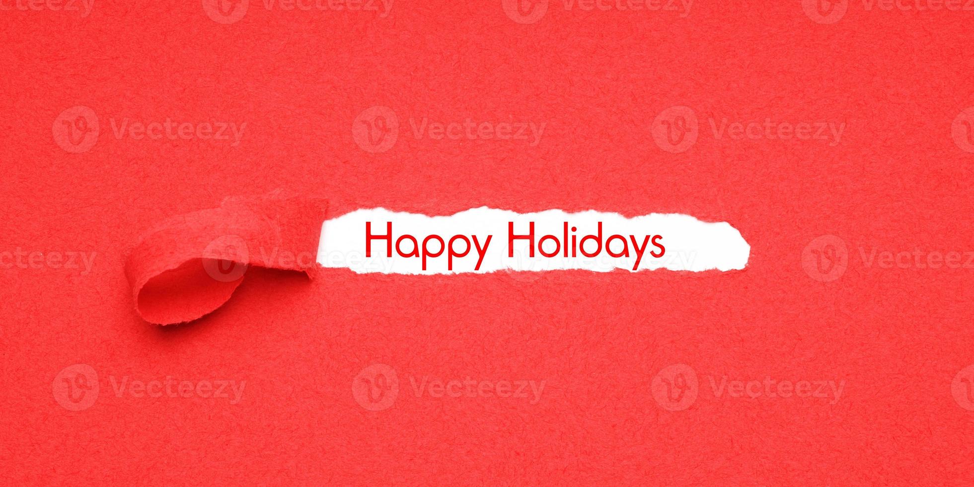 happy holidays peel away red paper background to reveal christmas greeting photo