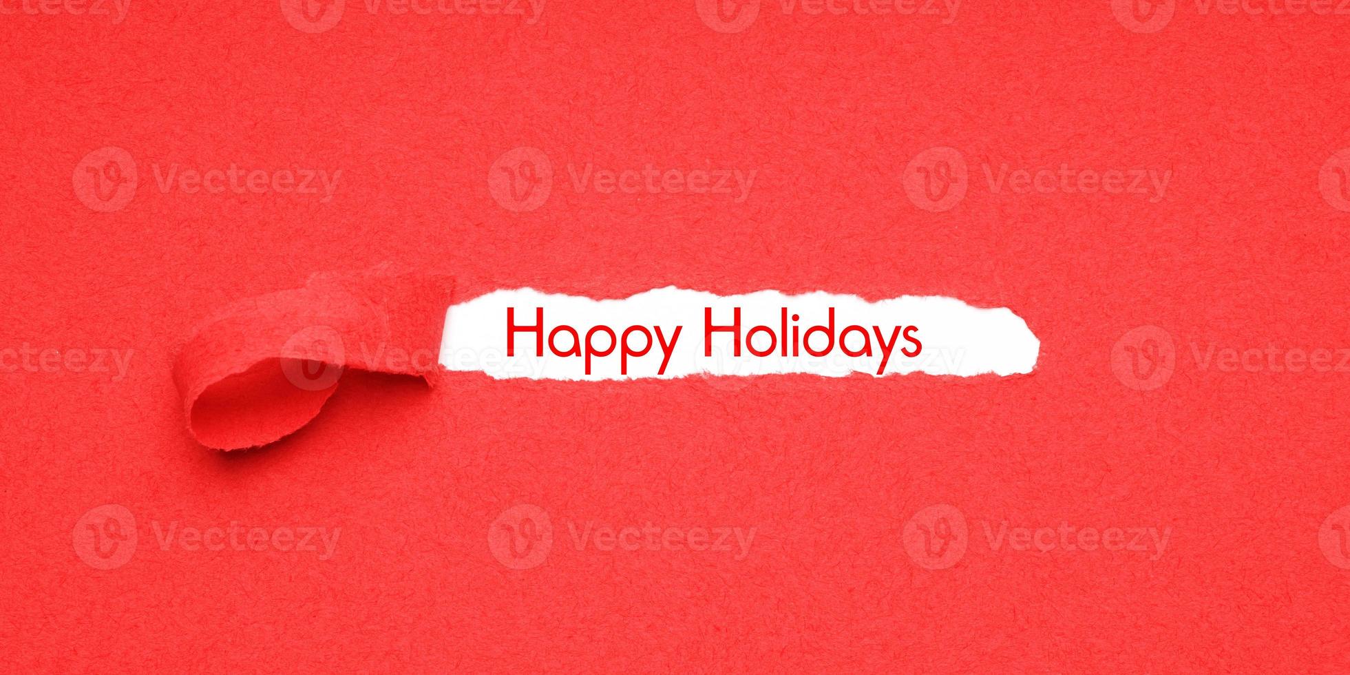 felices fiestas despegue el fondo de papel rojo para revelar el saludo de navidad foto