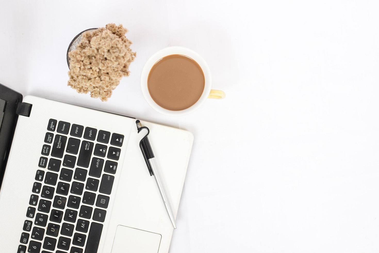 work desk with a cup of coffee isolated on white background photo