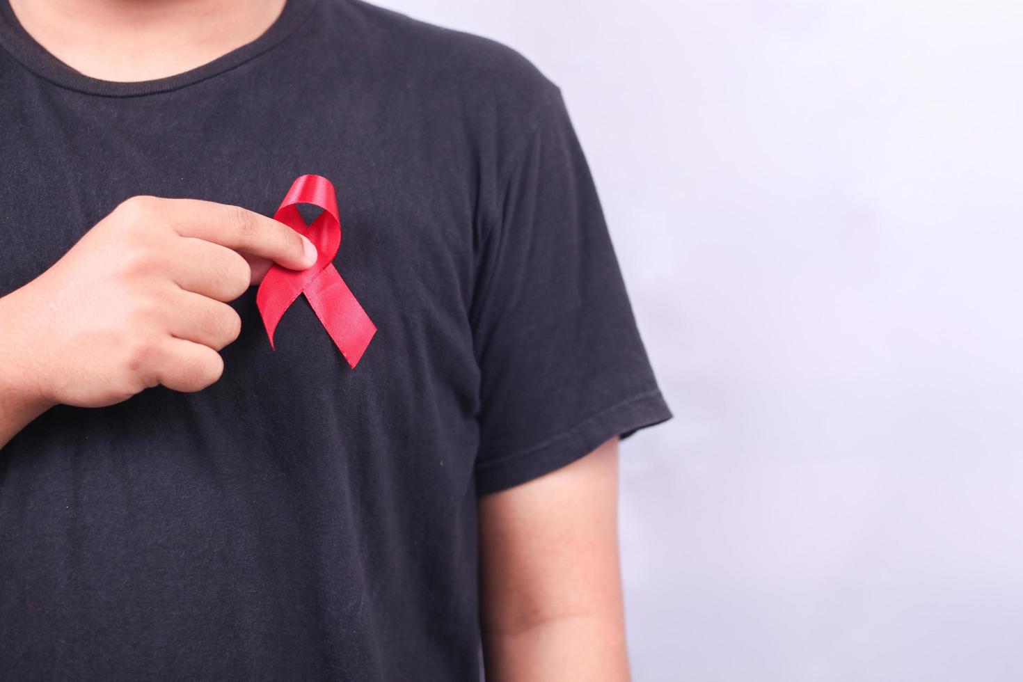 AIDS symbol with red ribbon against hiv isolated on white background photo