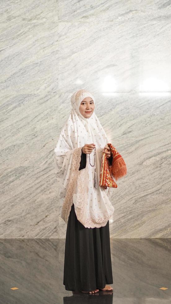 Asian Muslim woman finishes praying at the mosque photo