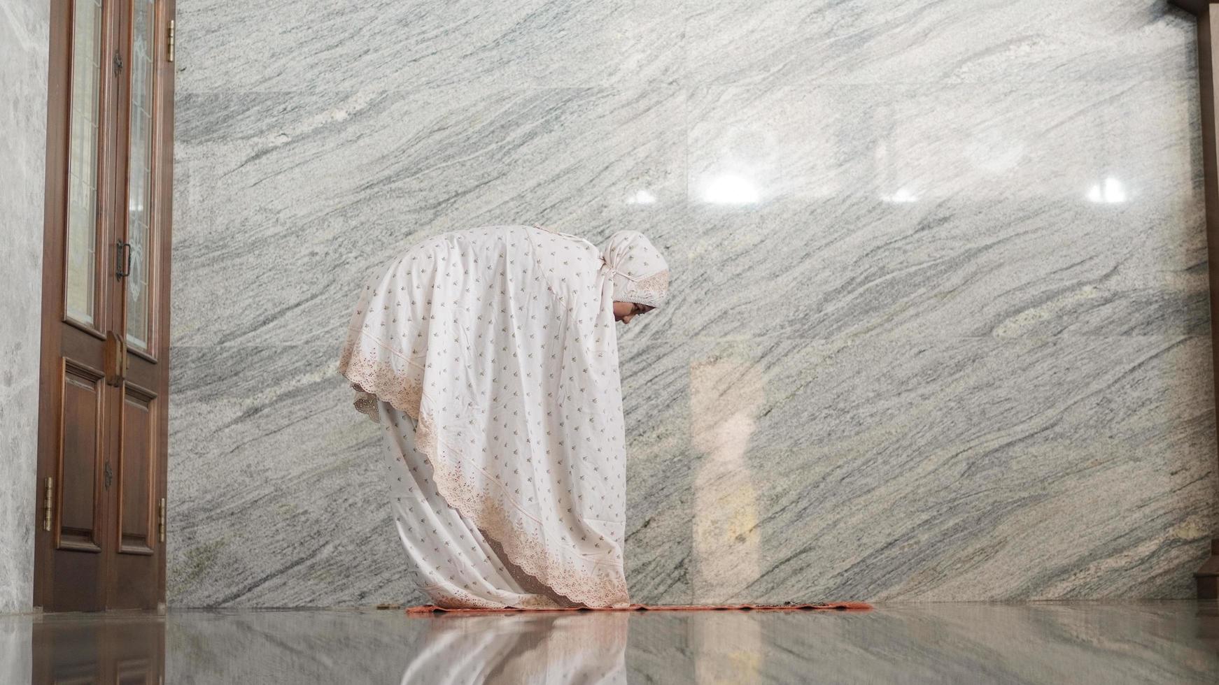 Asian Muslim women praying at the mosque photo