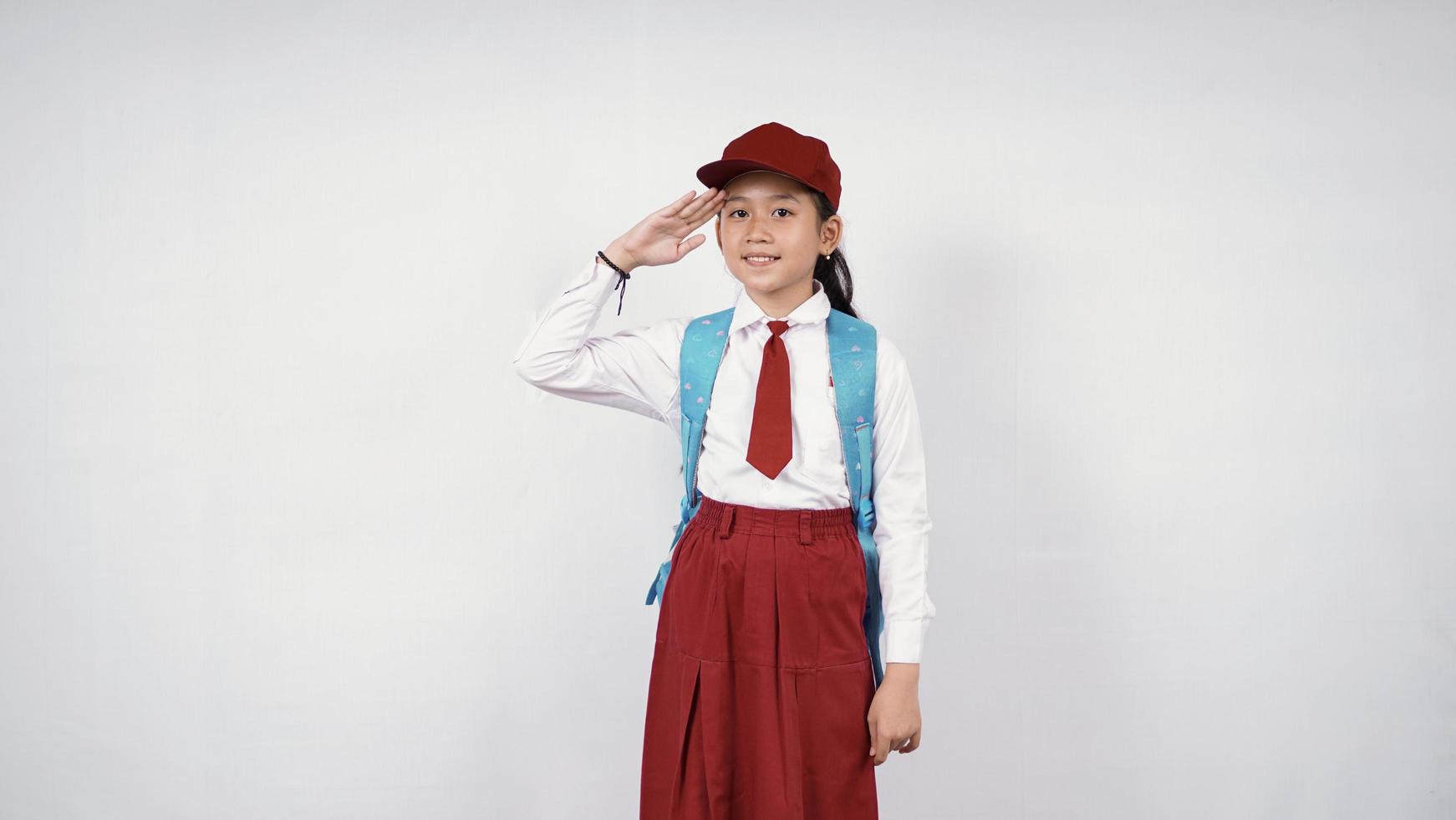 Respectful asian elementary school girl isolated on white background photo