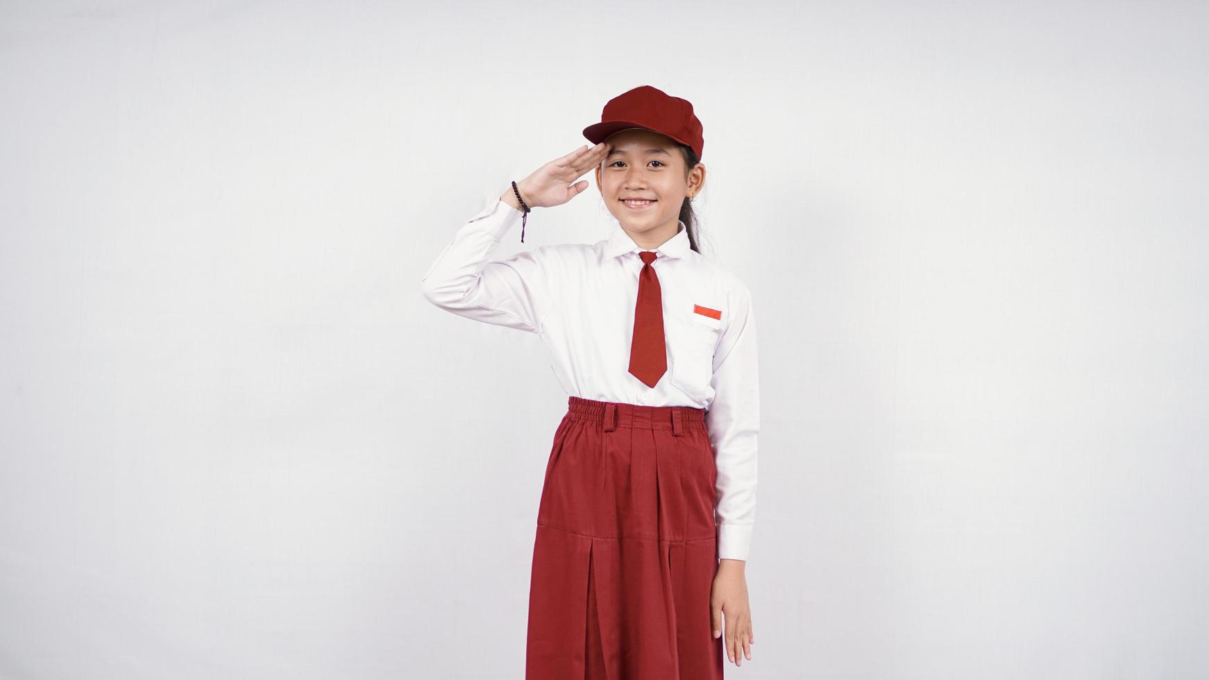 Respectful asian elementary school girl isolated on white background photo