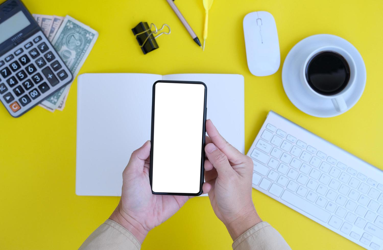 Blank notebook with pen is placed on an office desk table with computer tools and a range of materials. finance and banking background, flat lay, top view photo