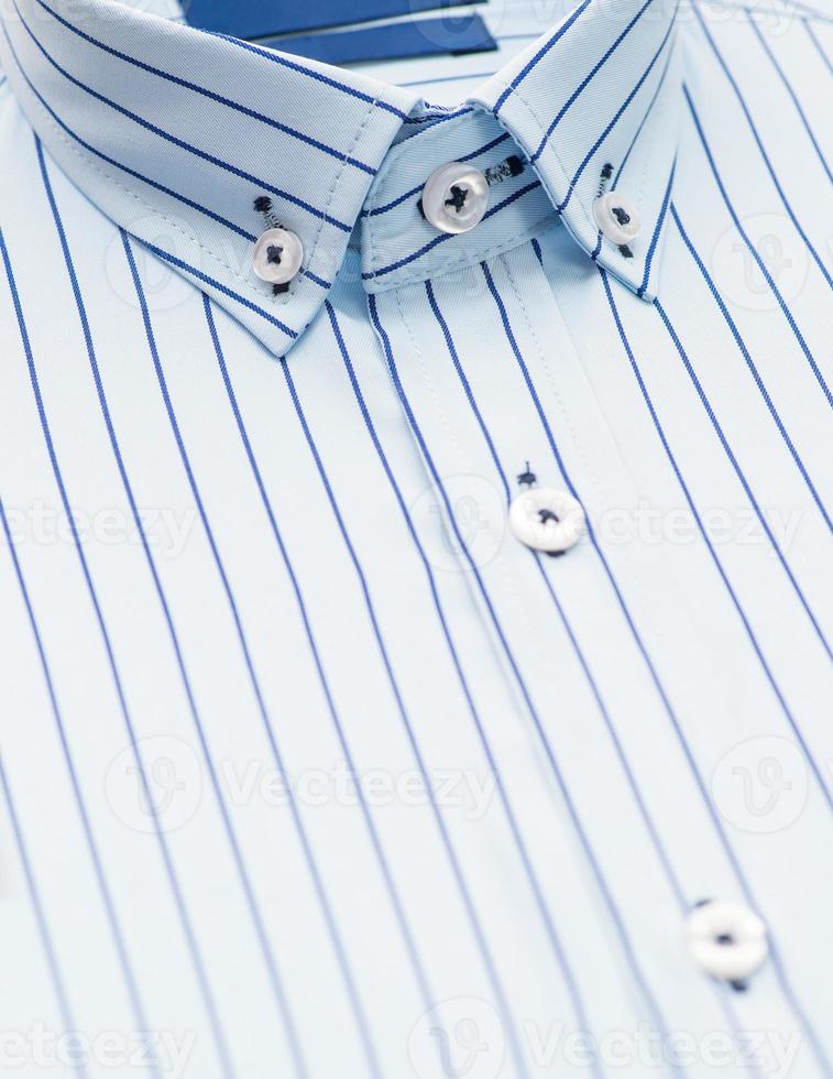 cotton shirt with a focus on the collar and button, closeup photo