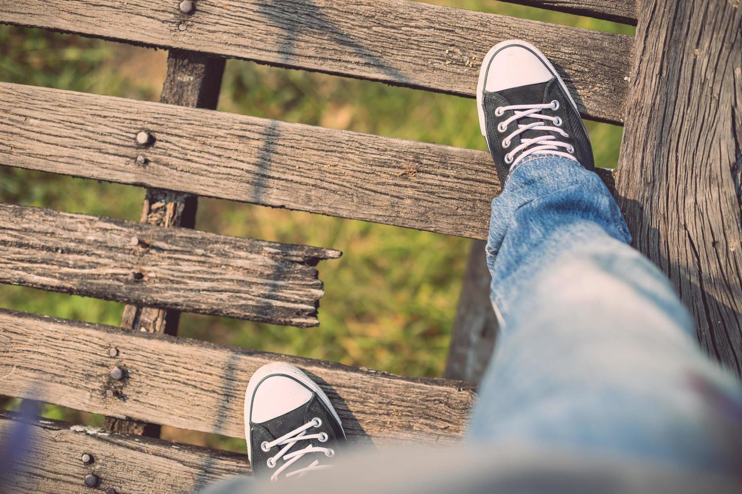 Asian tourist man walking on the old and broken wood bridge photo