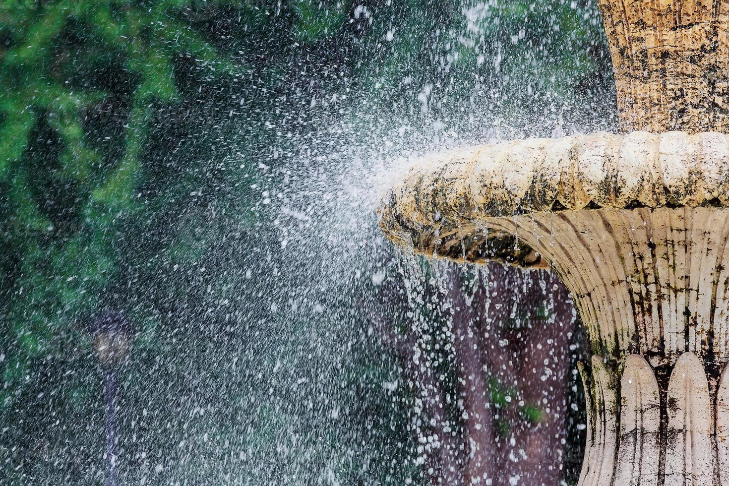 Water fountain in park. Splashing streams of in stream pouring from . on surface lake. in summer . photo