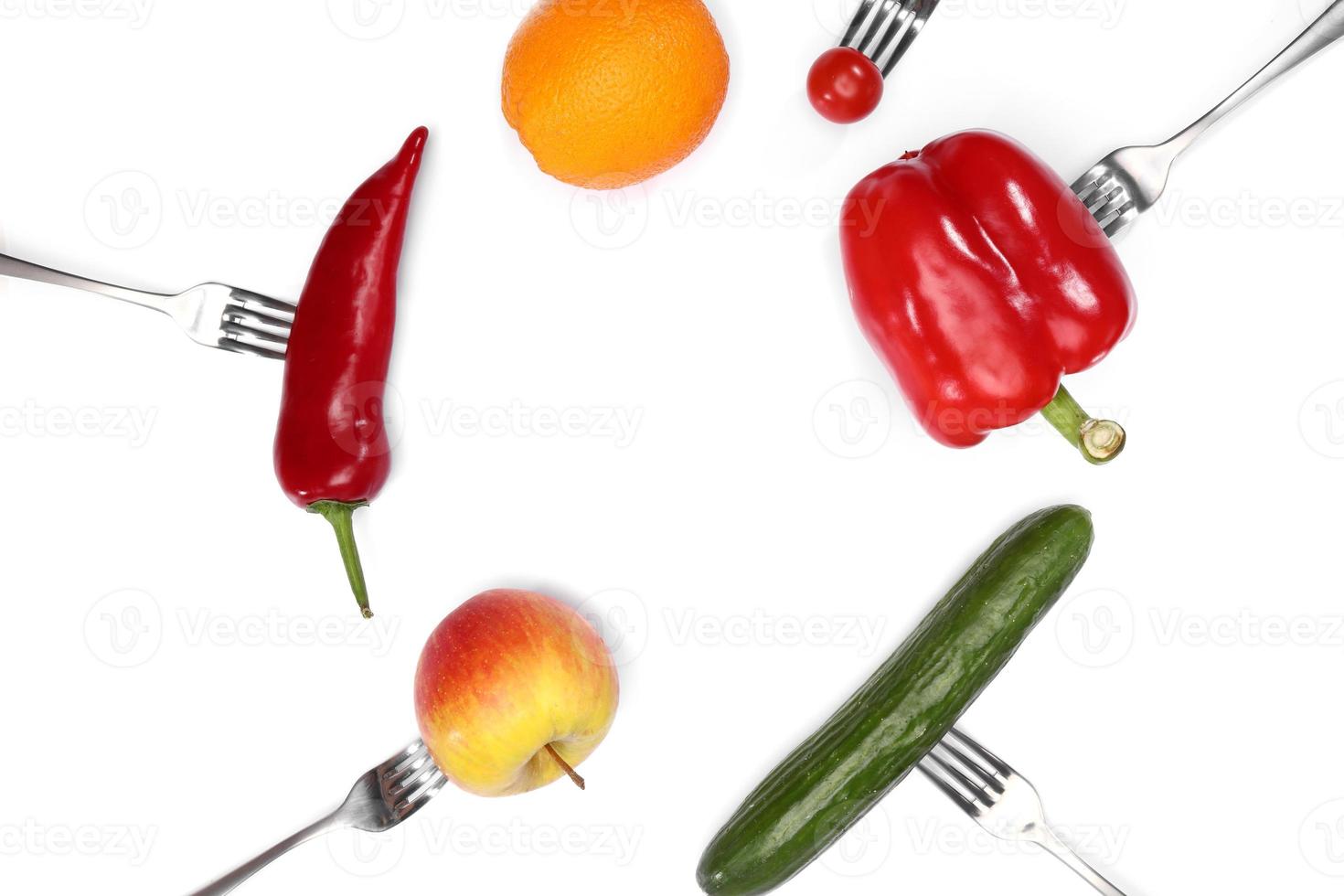 A healthy diet food. fresh cherry tomato, red pepper, cucumber, apple and orange fruits on forks on white background. Healthy eating and vegetarian food, cooking concept. photo