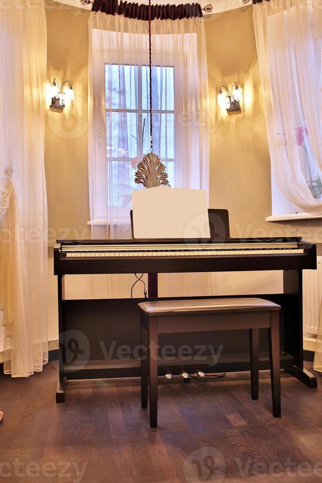 Old piano in the ancient house. The room is aged style. Interior of the home. photo