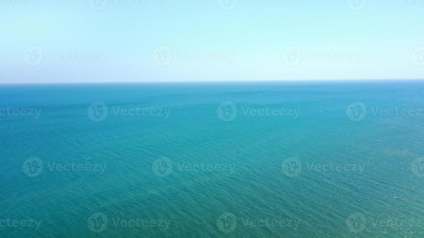 Aerial view of calm sea blue water and sky without clouds. place for text photo