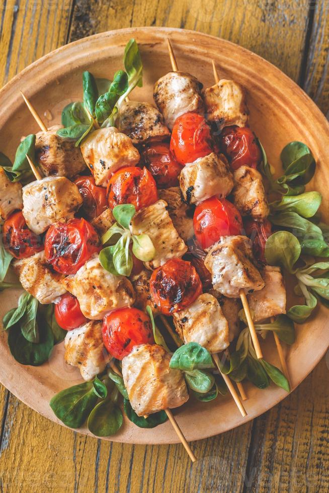 Grilled chicken skewers on the plate photo