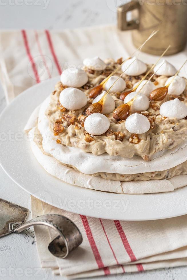 Pavlova cake with caramel and almonds photo