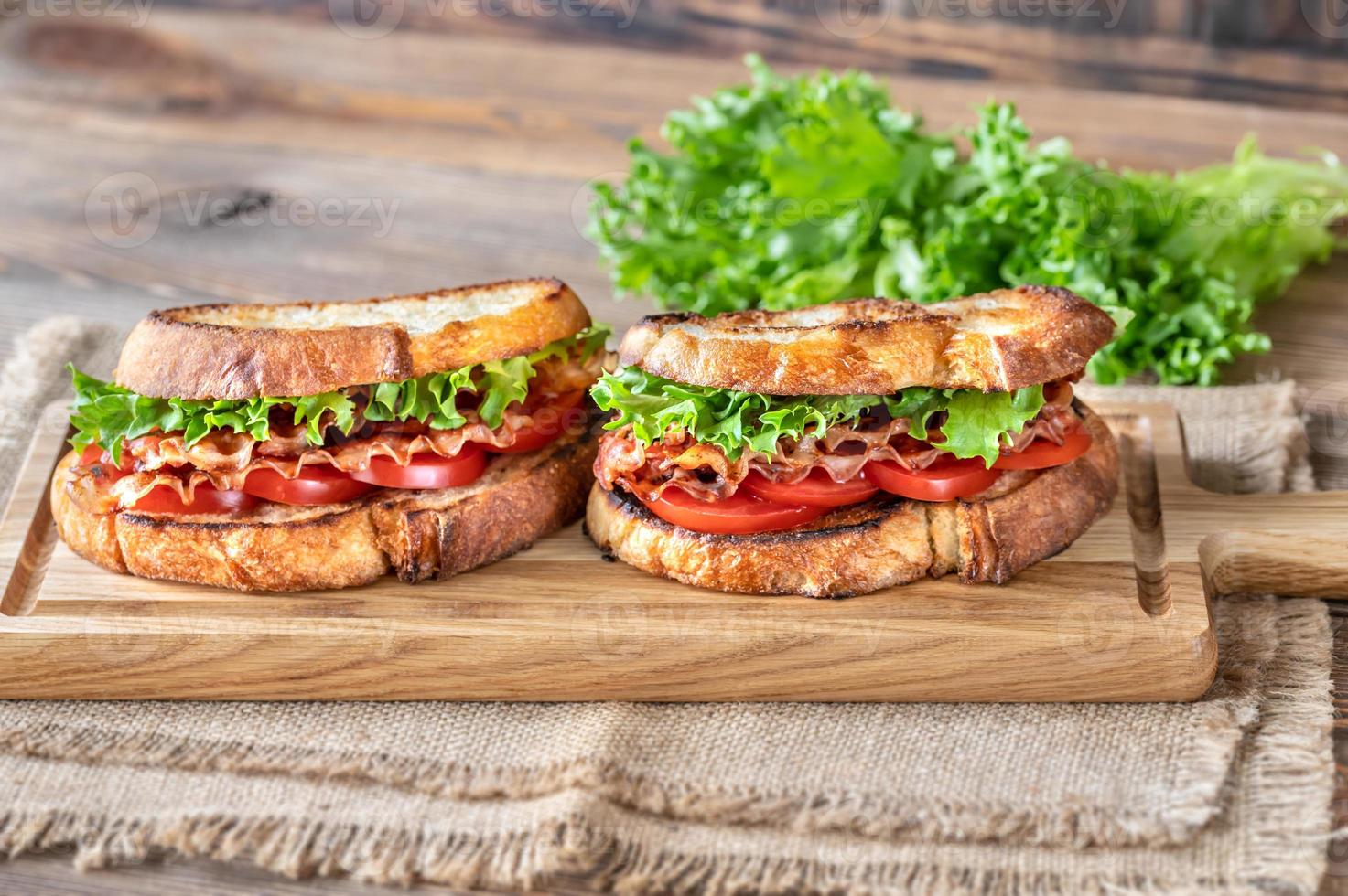 BLT sandwiches on the wooden board photo