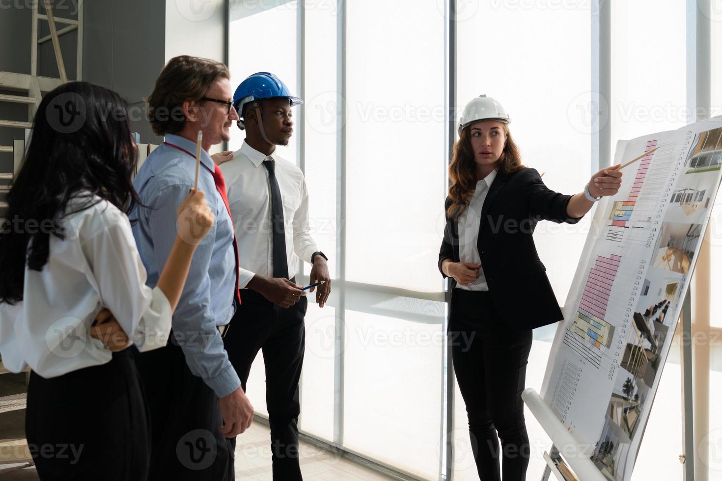 Young Architect Presenting Blueprint of Building to Client photo