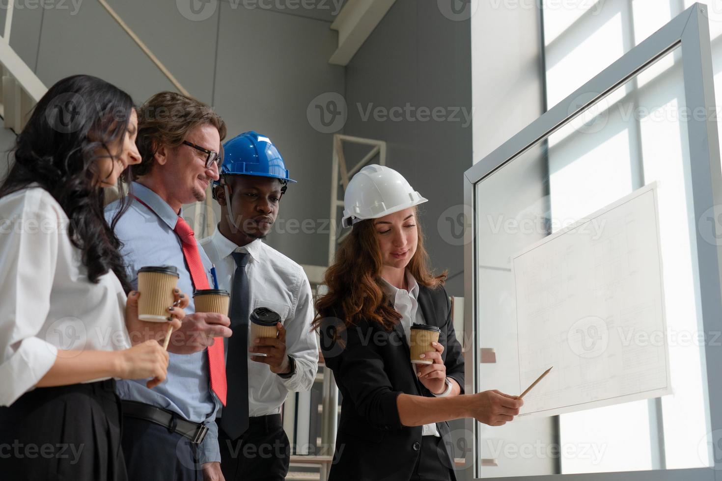 Young Architect Presenting Blueprint of Building to Client in Meeting photo