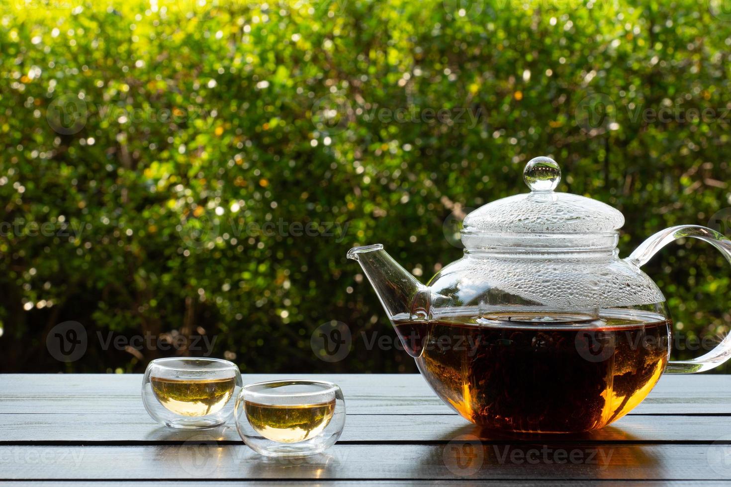 Hot Tea Was Poured into Glass Served on Table in Cafe photo