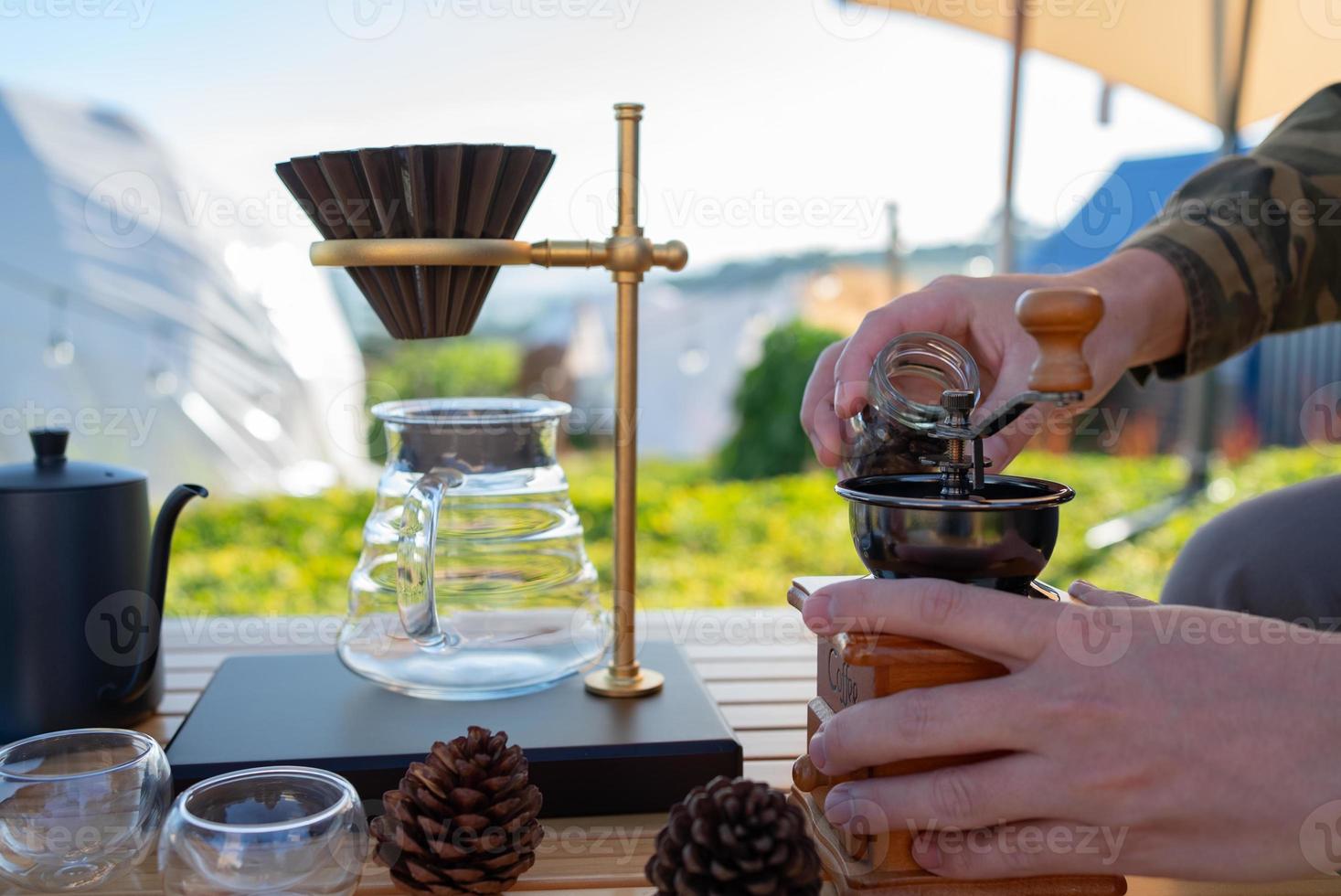 Man Grinding Coffe Bean to Make Coffee photo