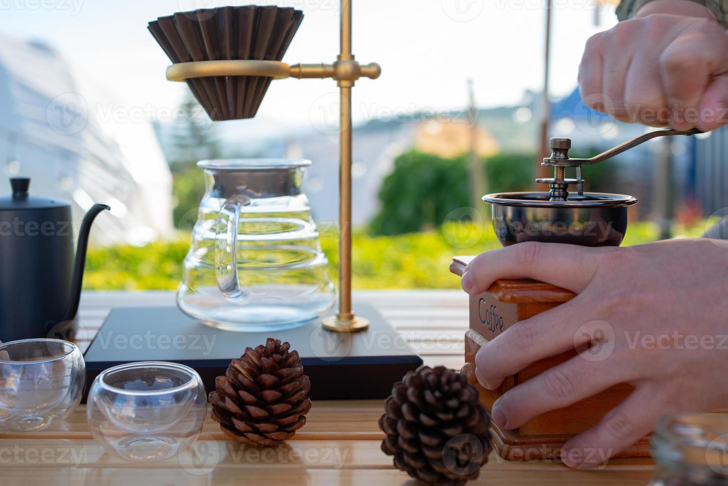 Man Grinding Coffe Bean to Make Coffee photo