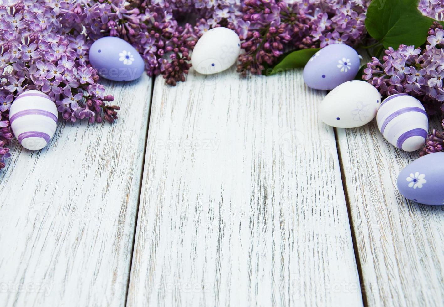 easter eggs and fresh lilac flowers photo
