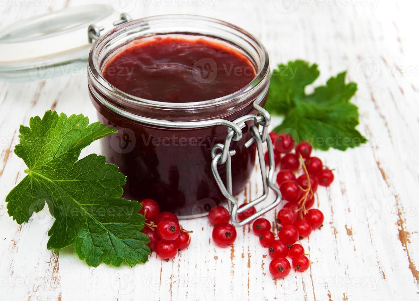 Redcurrants jam on table photo