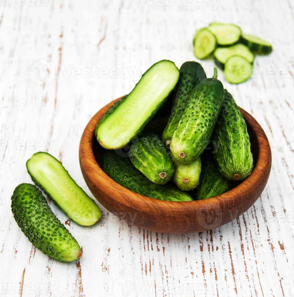 Fresh cucumbers on table photo