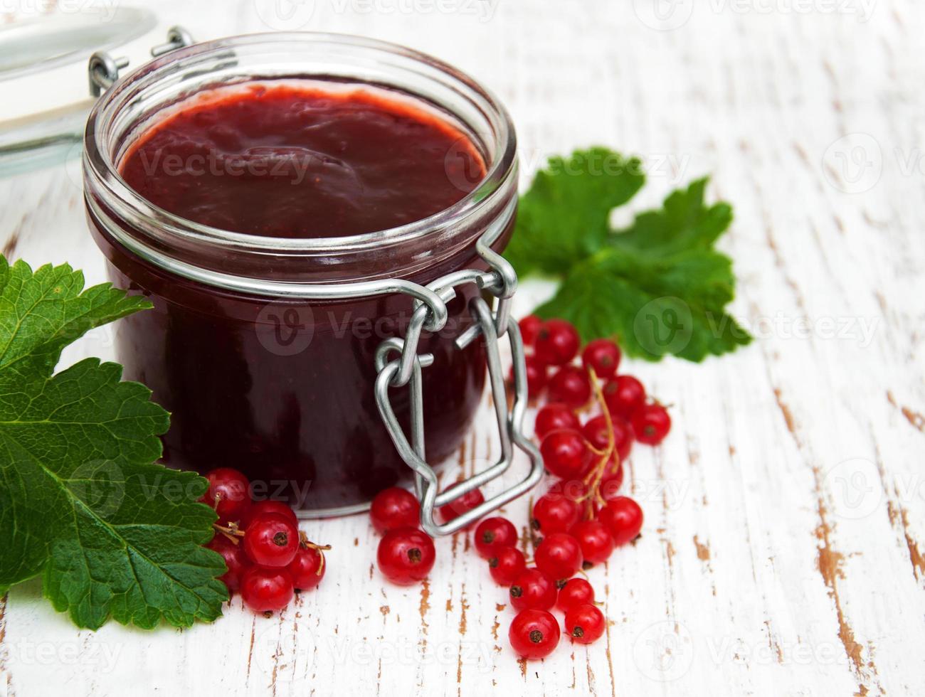 Redcurrants jam on table photo