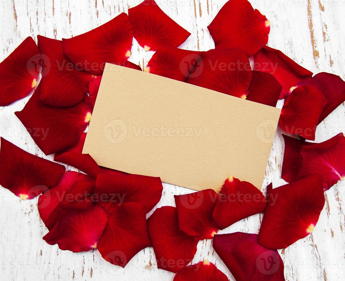 Red roses petals with card photo