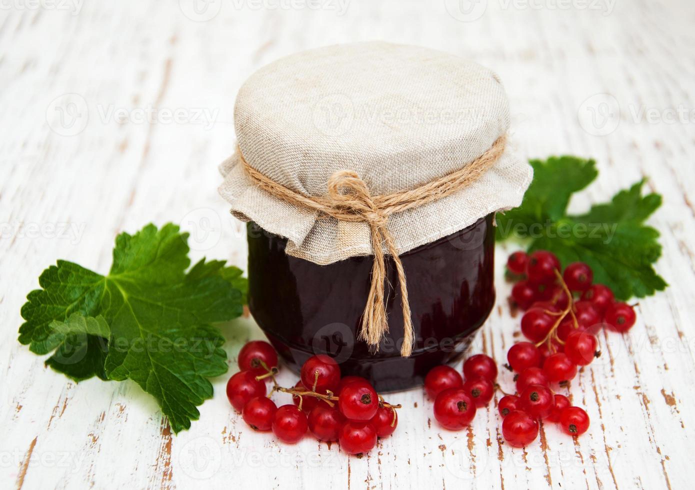 Redcurrants jam on table photo