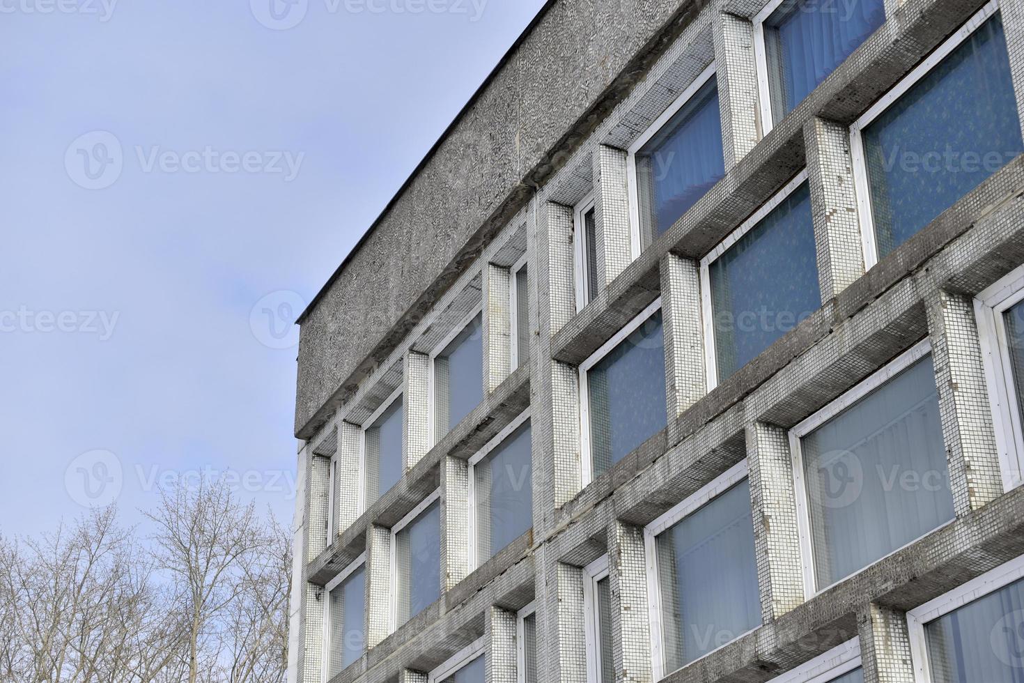 An old stone building with large windows photo