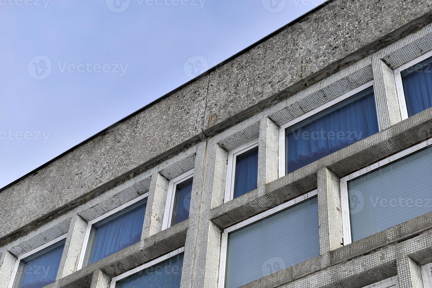 An old stone building with large windows photo
