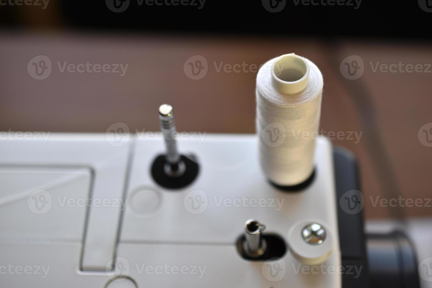 New White sewing machine with threads at home photo