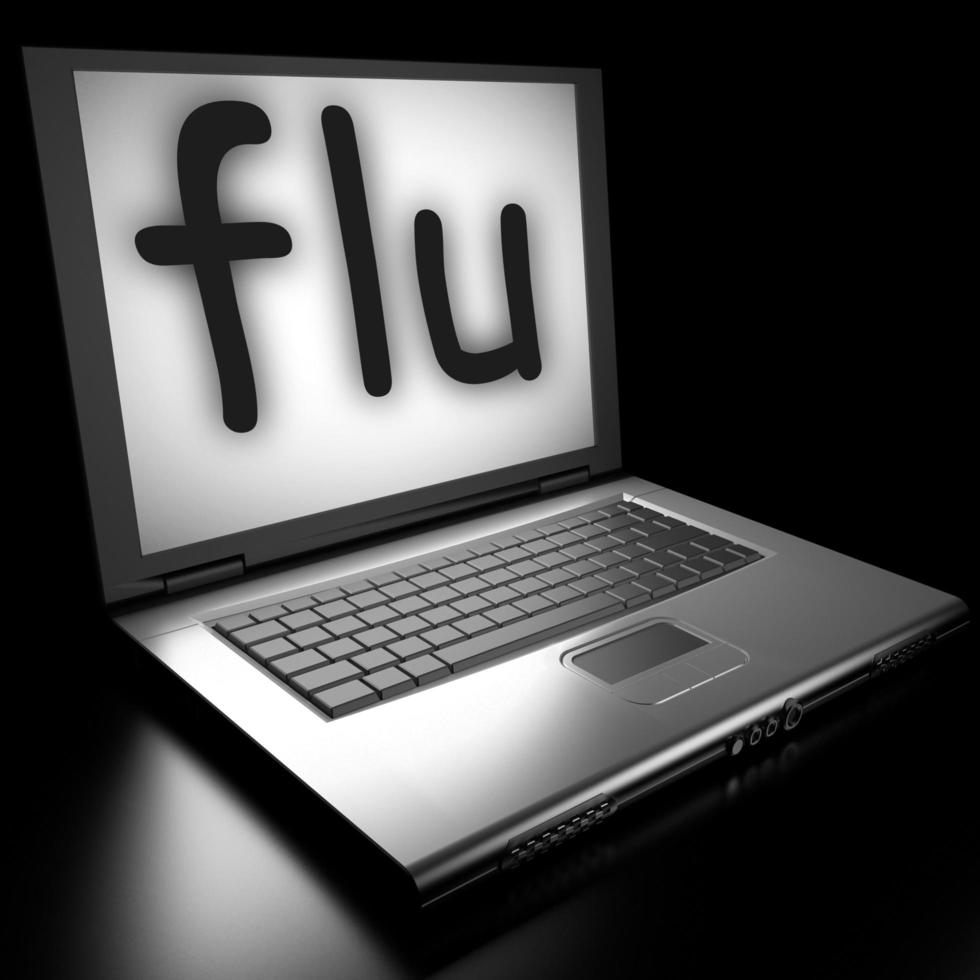 palabra de gripe en la computadora portátil foto