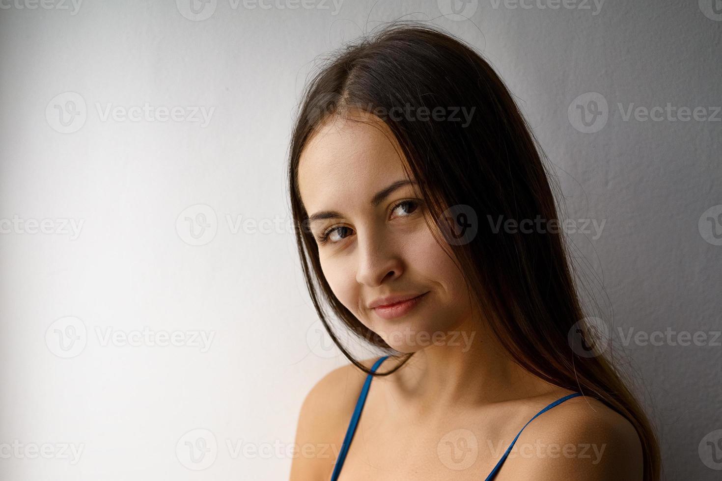 portrait of a cute girl in a blue bodysuit smiling photo