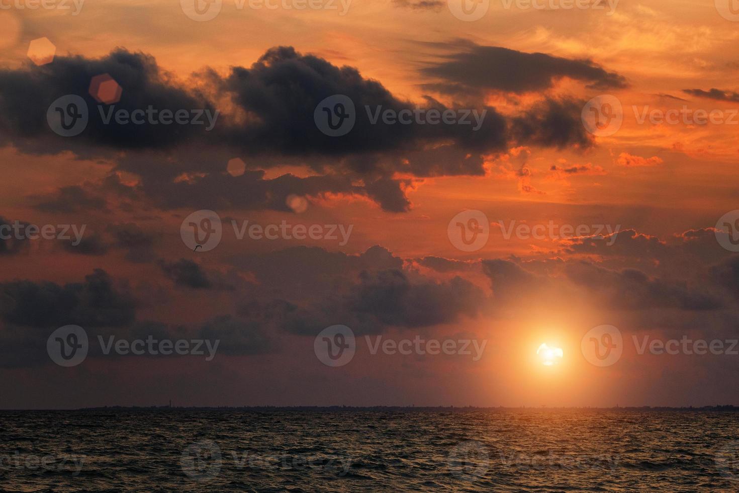 Sunset sky with clouds over the horizon over the sea, gloomy sky photo