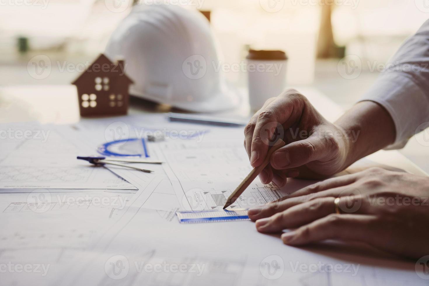 The partnership engineering man or co-workers working on a project and discussing together with looking at blueprint paperwork. photo