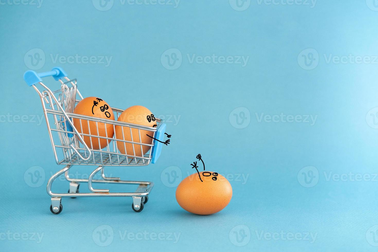 Store toy cart with brown eggs, funny faces painted on the shell. On a blue background.  Concept photo