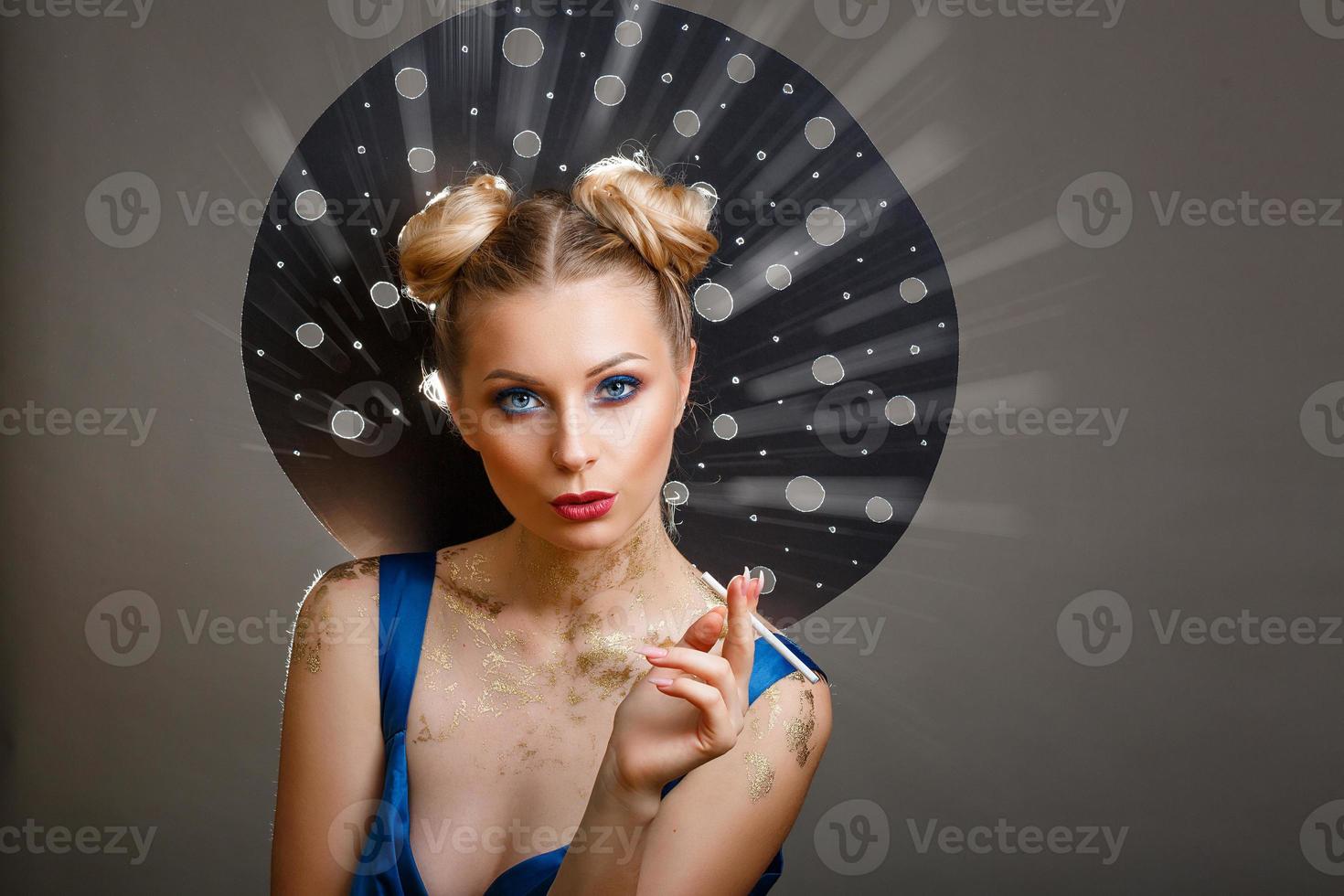 glamorous portrait of a beautiful woman with a cigarette in her hands photo