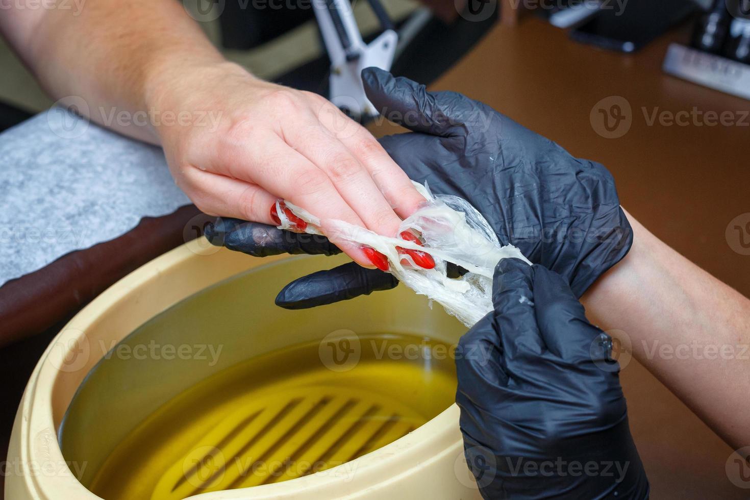 hand care with hot wax, covering with wax, manicure salon photo