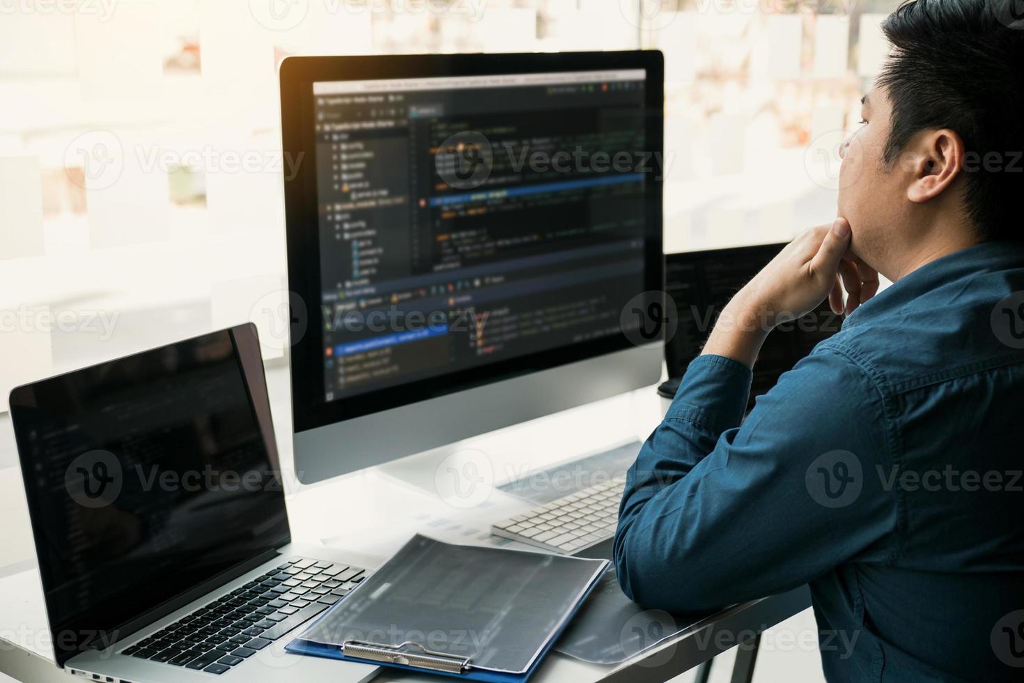 Asian man working code program developer computer web development working design software on desk in office. photo