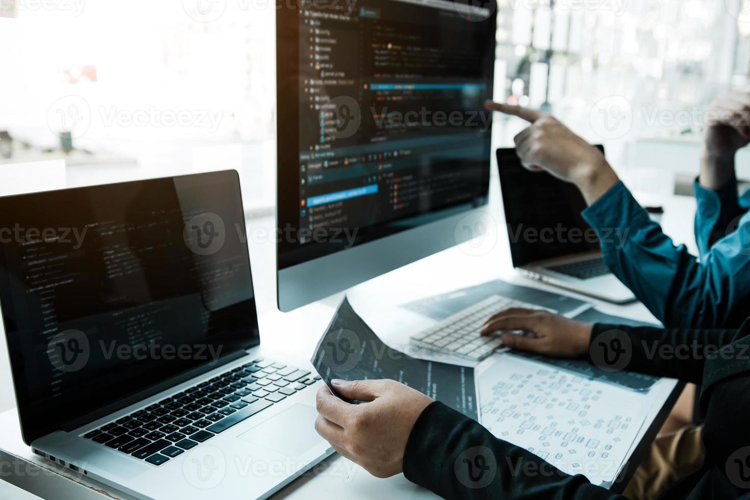 Two asian team working development of programming and encryption technology website design programmers on desk in office. photo