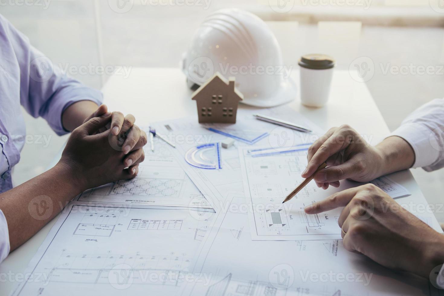 Team architect or engineering people discussion working on table together at a construction site. photo