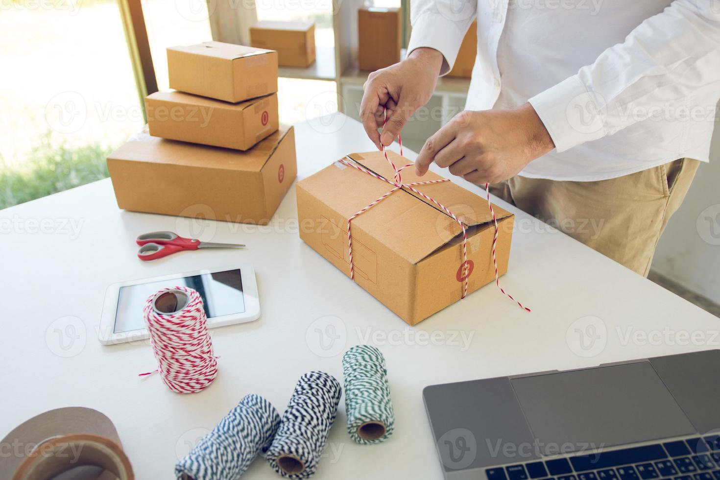 Young asian teenage product owners are packing small business packaging products in boxes prepared for shipping. photo