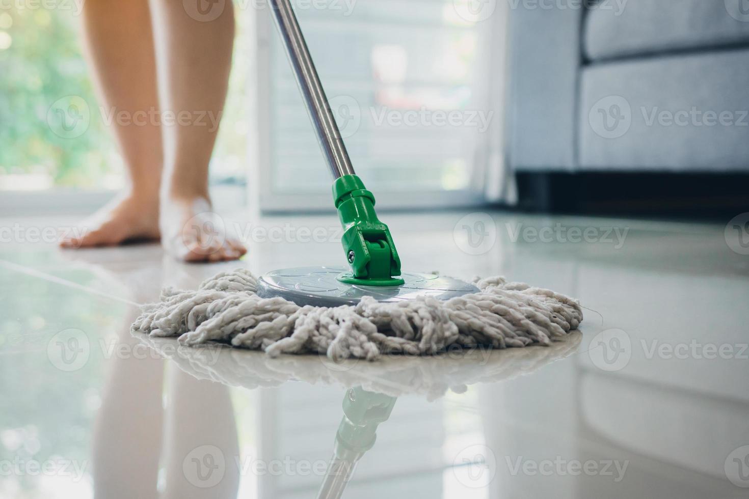 Asian women cleaning folk using mop tiles. photo