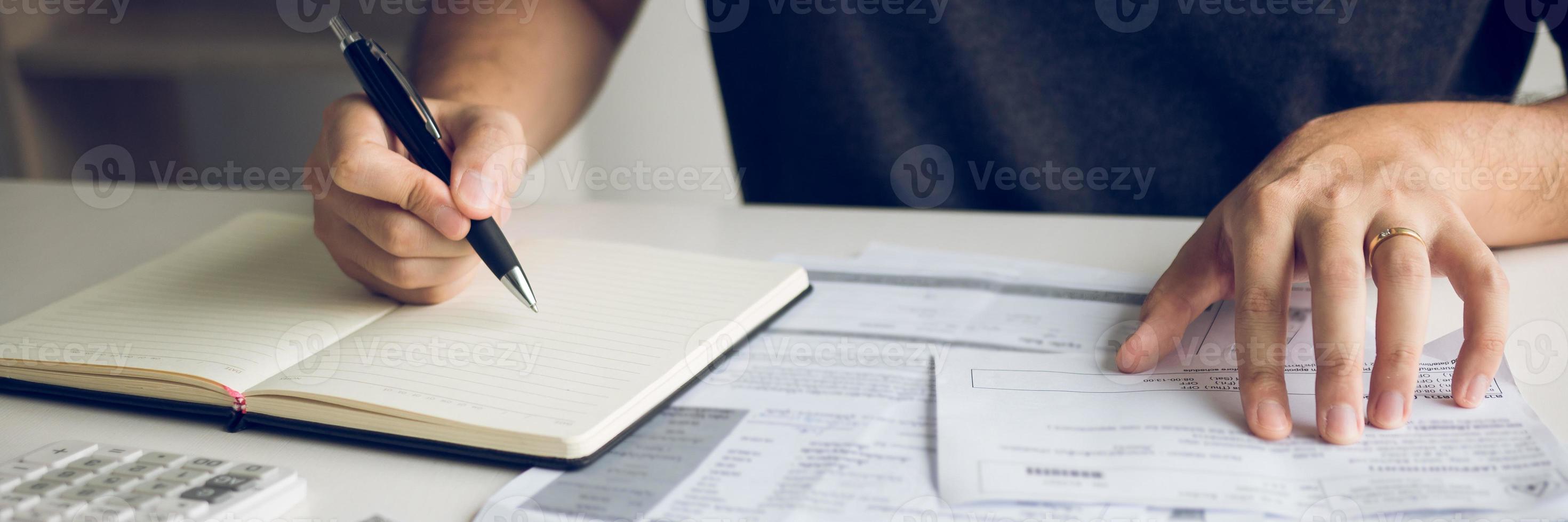 Man use calculators and documents that calculate expenses in the home