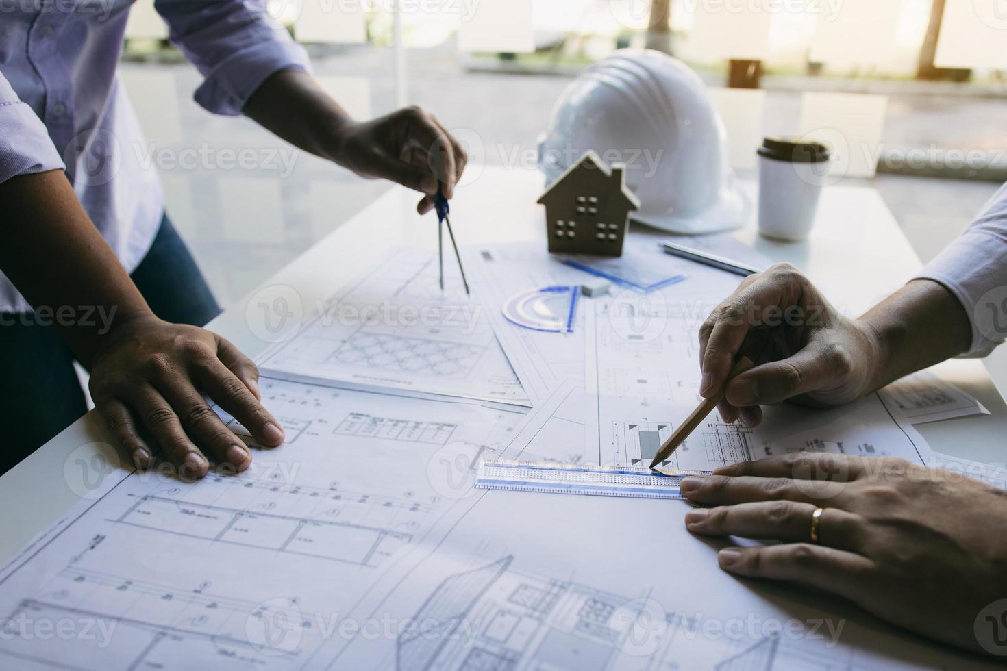 Team architect or engineering people discussion working on table together at a construction site. photo