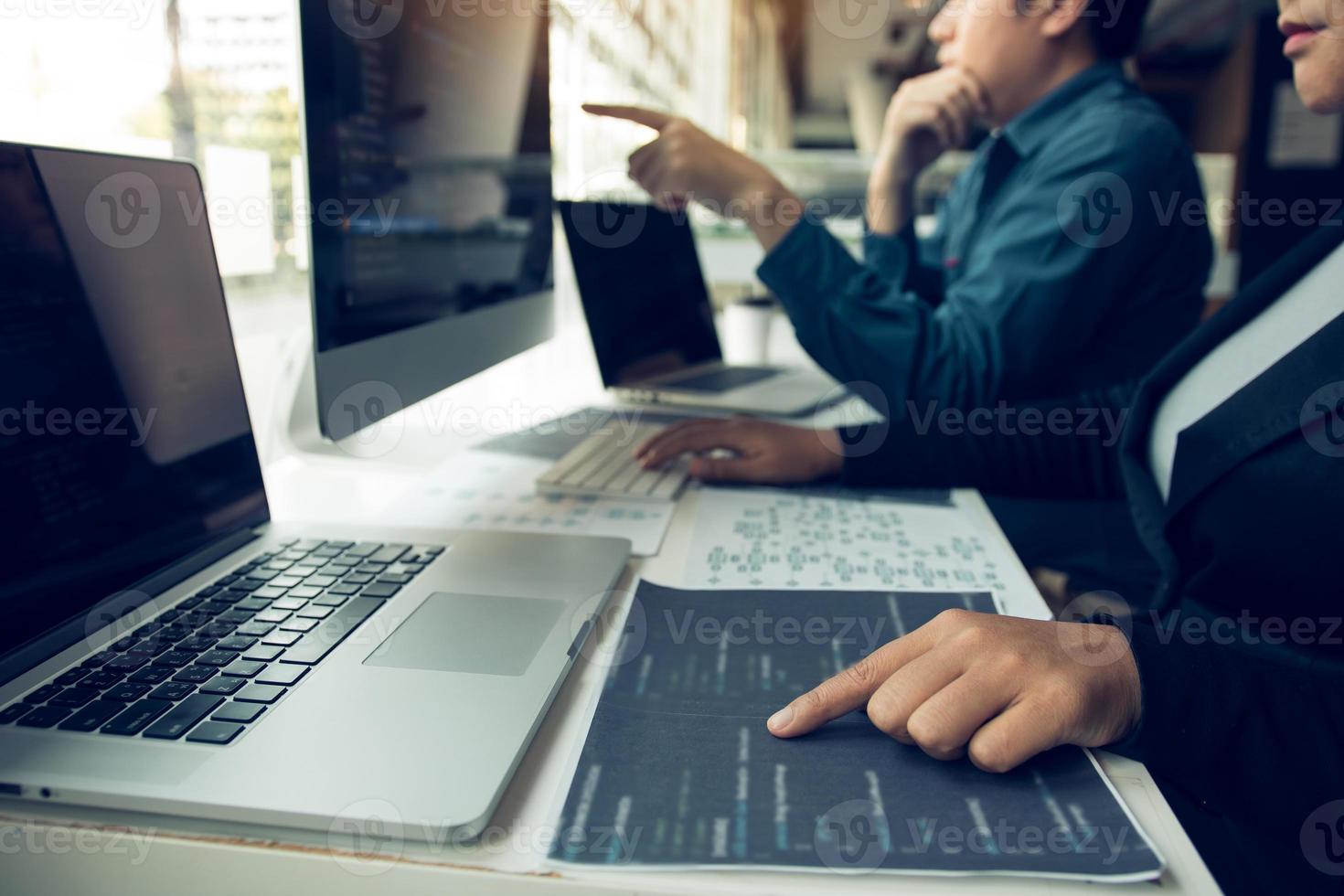 Two software developers are analyzing together about the code written into the program on the computer. photo