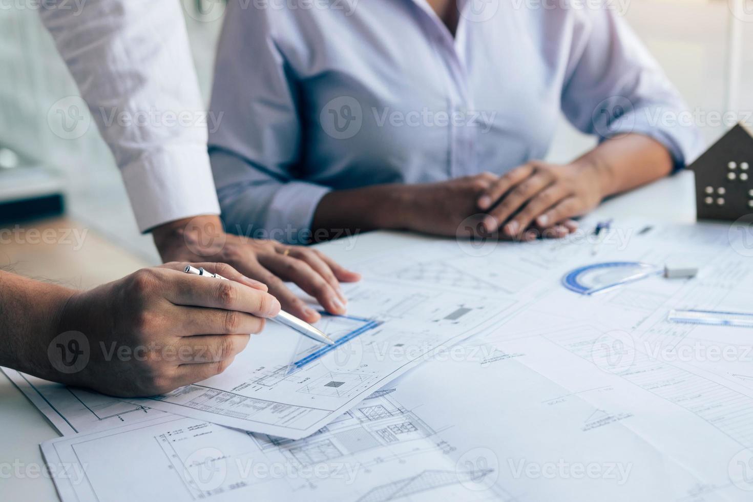 Team architect or engineering people discussion working on table together at a construction site. photo