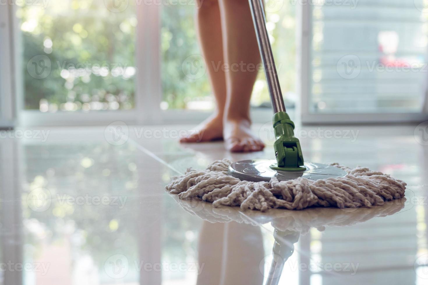 Asian women cleaning folk using mop tiles. photo