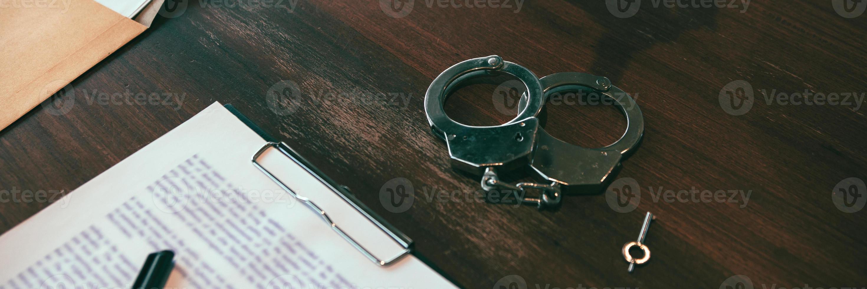 The handcuffs are placed on the desk in the investigation room. photo